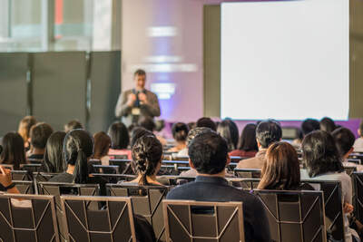 People in a conference room listening to the speaker
